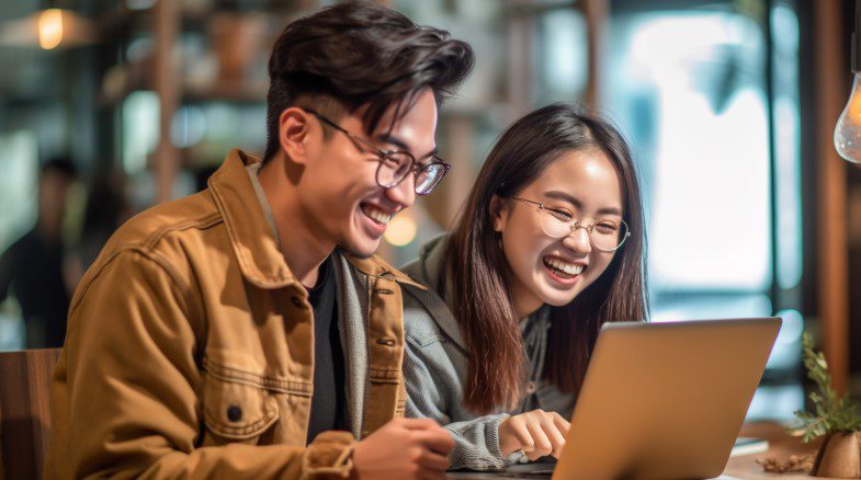 a couple looks at an email on their laptop