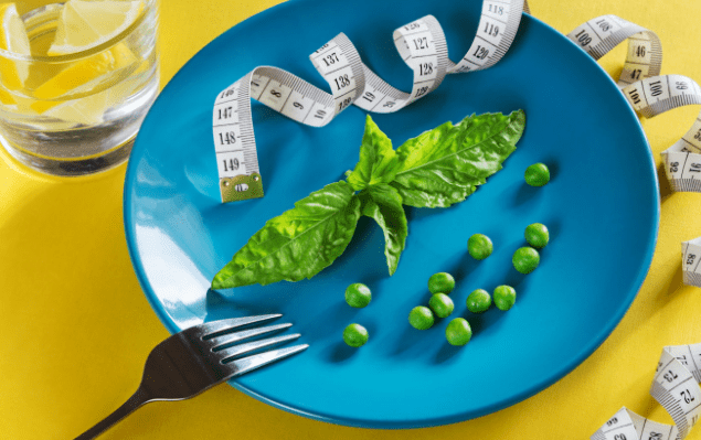 peas and a measuring tape on a plate