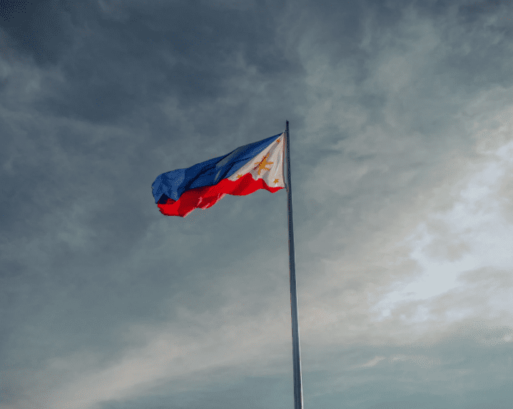 the philippine flag against a dark sky