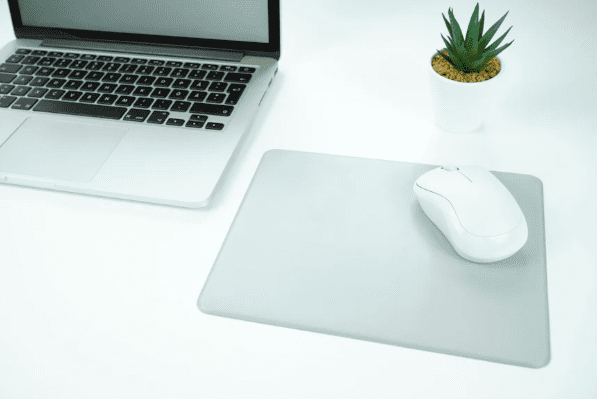 Laptop and mouse on a white desk